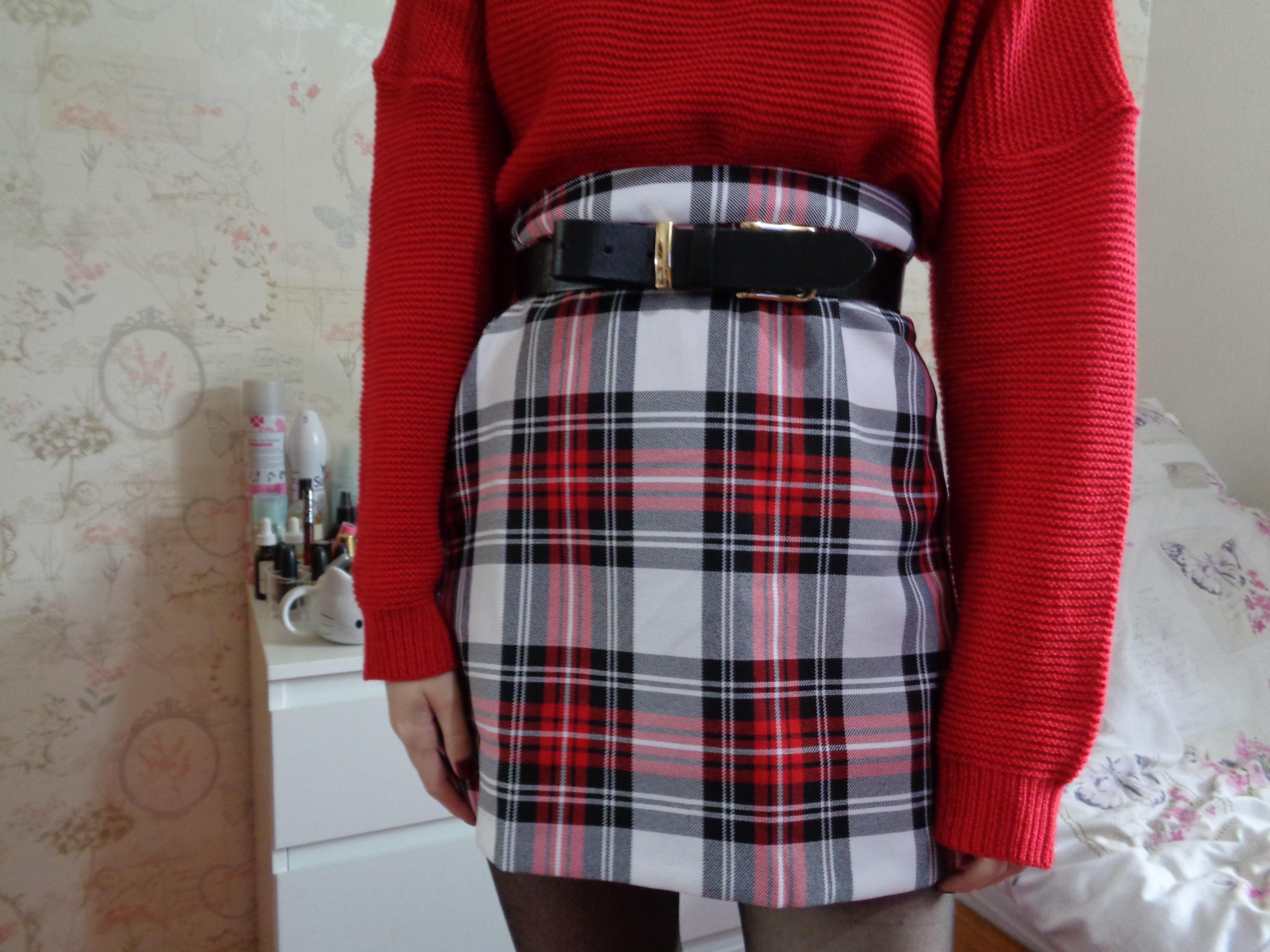 ASOS Red Check A-Line Skirt photographed up close, secured in place with a simple black belt, and with the Missguided High Neck Red Jumper tucked into it.