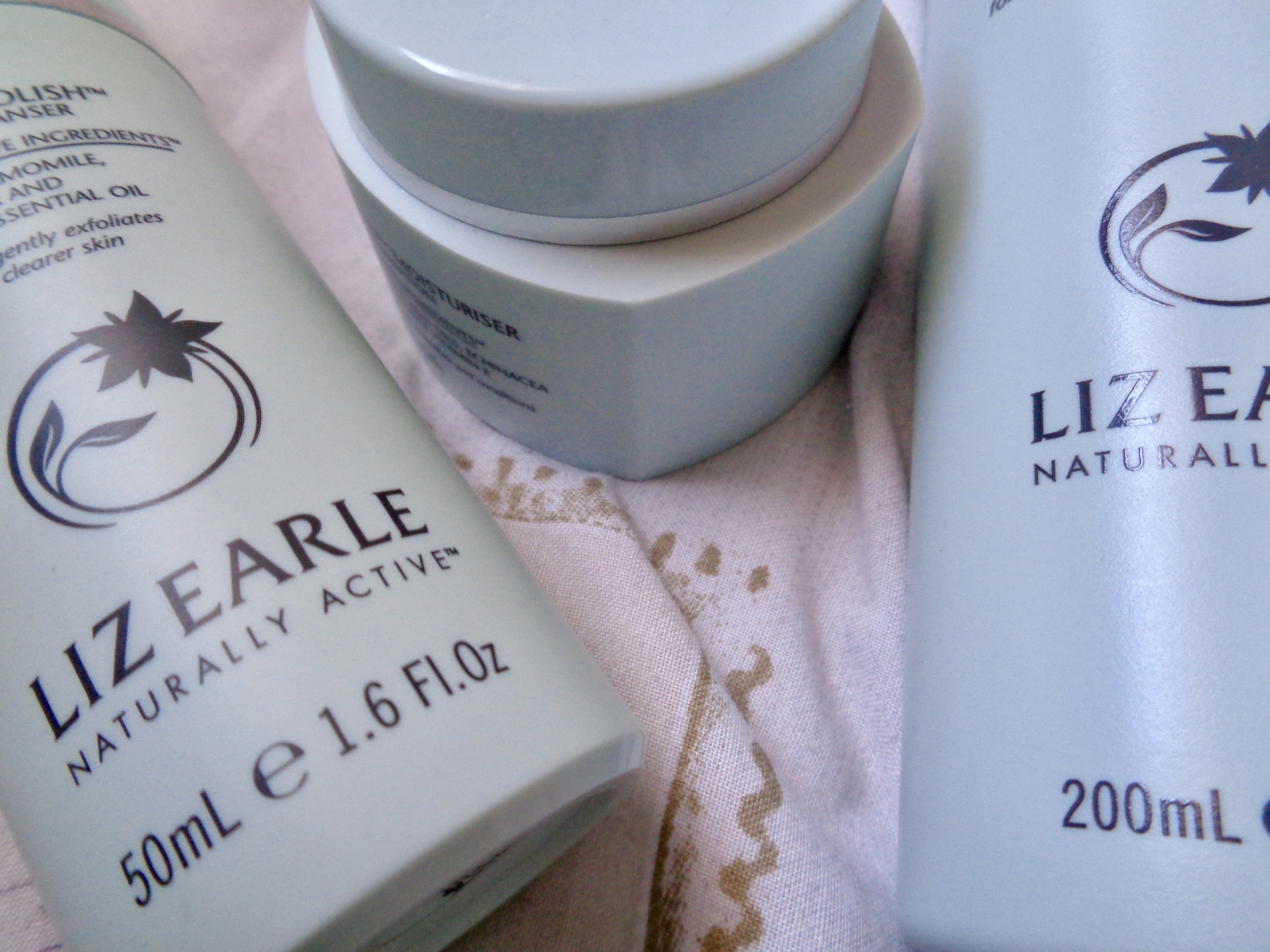 An extreme close up of 3 Liz Earle products