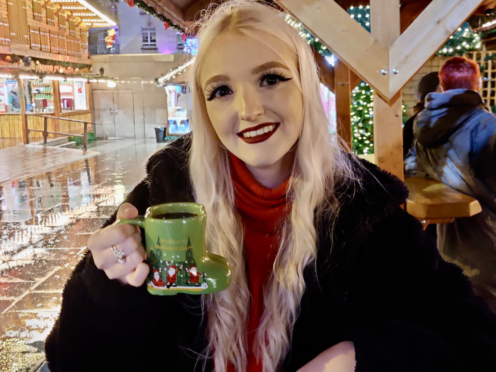 Decorative image of Flossie holding a mug of mulled wine at Leeds Christmas Market